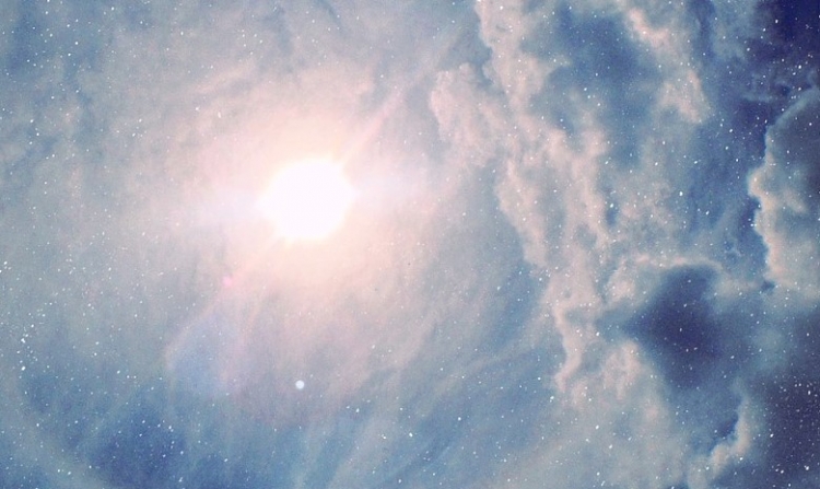 light cloudy sky with the sun shining through