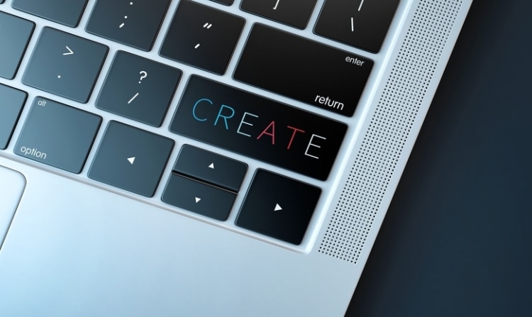 laptop with a colorful create button on the keyboard.